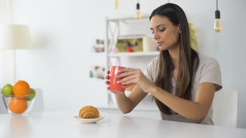 Woman Having Lunch, Drinking Coffee With Croissant Feeling Toothache From Sweets