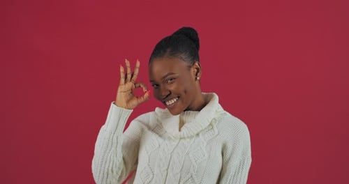 Smiling Woman Gesturing Okay and Waving