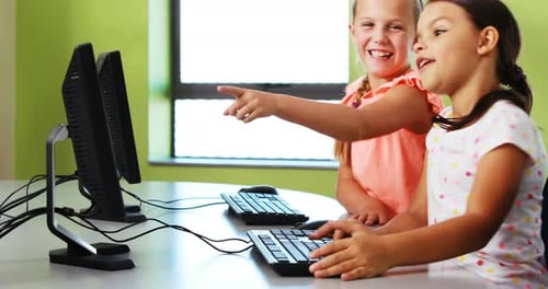 Girls Working Together on Computers in Classroom