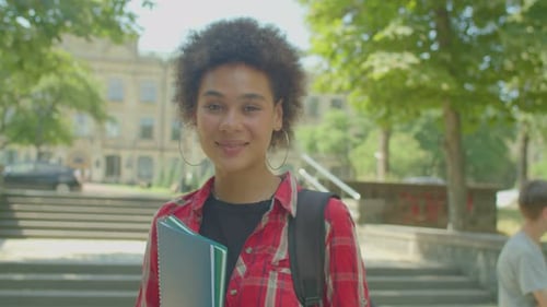 Smiling College Student on Campus with Books
