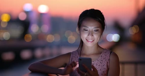 Woman use mobile phone at night