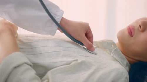 Doctor Listens to Patient's Lungs With Stethoscope