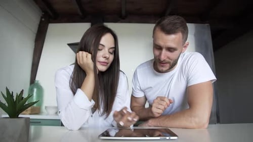 Young Couple Using Tablet Device Together at Home