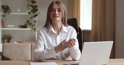 Portrait of Young Active Smiling Business Woman Sitting in Office at Table in Successful Company