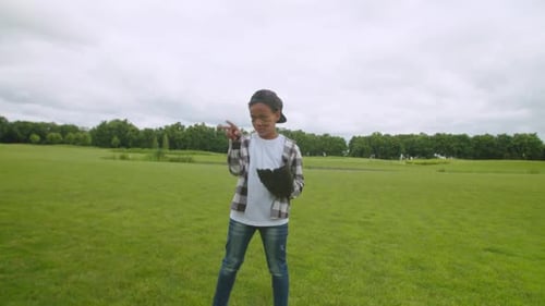 Portrait of Cute Little African Boy Pitcher Throwing Baseball Outdoors