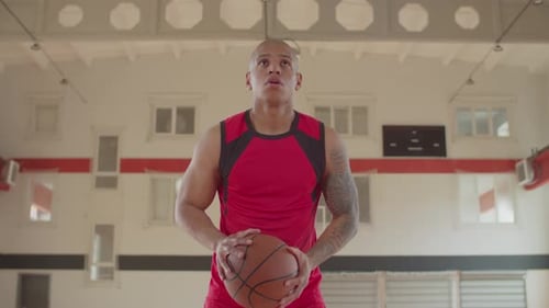 Man Practicing Basketball in School Basketball Court