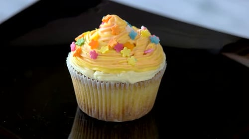 Colorful Cupcake with Yellow Icing and Sprinkles