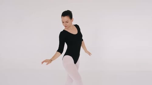 Woman Dancing Gracefully in Ballet Studio