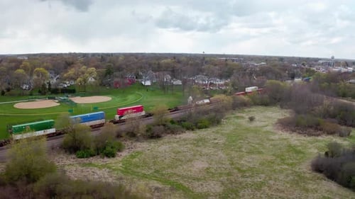 Aerial View of Train Traveling Through Suburban Area
