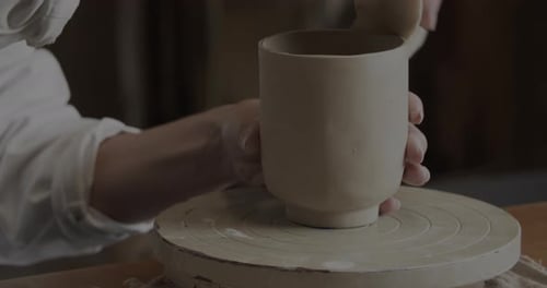 Hands Smoothing Clay on Pottery Wheel, Art Project