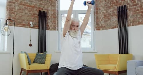Senior Man Lifting Dumbbells at Home