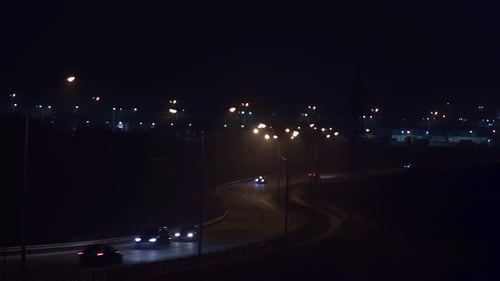 Night Car Traffic on a Village Road Outside the City