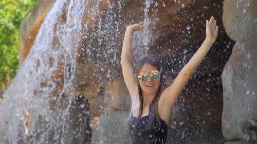A Young Woman in a Tropical Resort with Hot Springs, Waterfalls and Swimming Pools with Hot Mineral