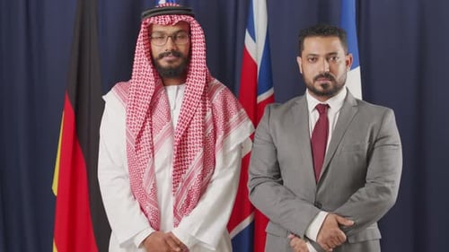 Men Stand Before Flags in Formal Attire