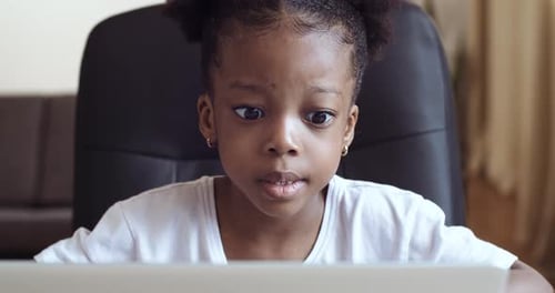 Concentrated Girl Using Computer at Home