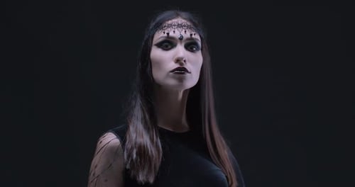 Woman with Dramatic Makeup Posing in the Dark