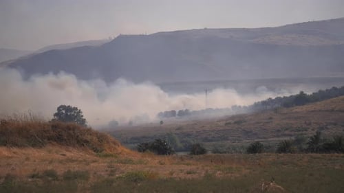 Smoke rising above the burning field