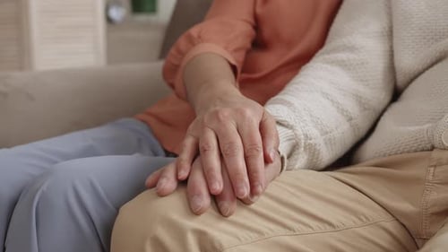 Senior Couple Holding Hands with Love Indoors