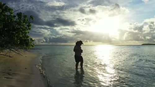 One girl posing on exotic shore beach time by shallow sea with white sand background of the Maldives