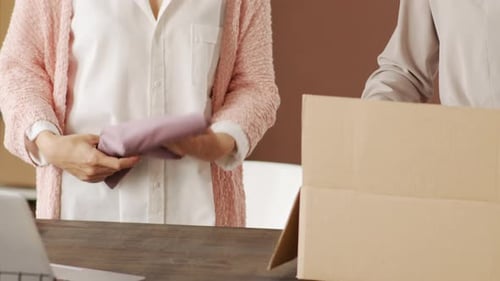 Unrecognizable Women Packing Order for Online Clothes Shop