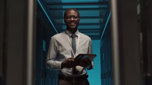 IT Specialist Checking on Operational Server Racks