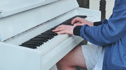 A Street Pianist Plays the Piano in the City