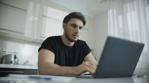 Man Working From Home on Laptop