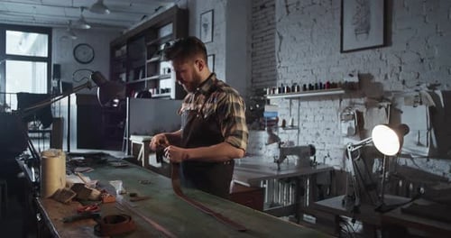 Man Crafting Leather in Rustic Workshop Environment