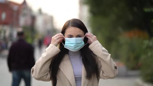 Portrait of a Mixed Race Woman in the City Streets During the Day, Wearing a Face Mask Against the
