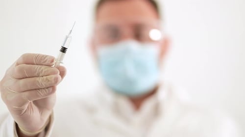 Close Up Of Needle Being Held By Medical Professional