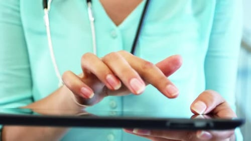 Doctor using digital tablet at the hospital
