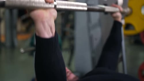 Close Up of the Hands of a Man Raising the Barbell Slow Mo