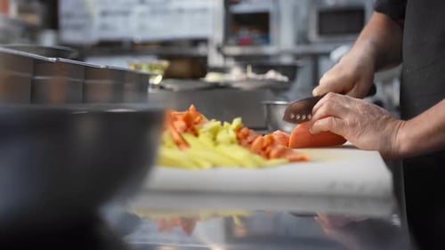 Chef Slicing Carrots in a Restaurant Kitchen