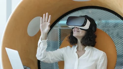 Woman Using VR Headset in Modern Workplace