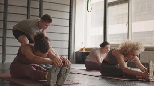 Group of Women Stretching in Gym