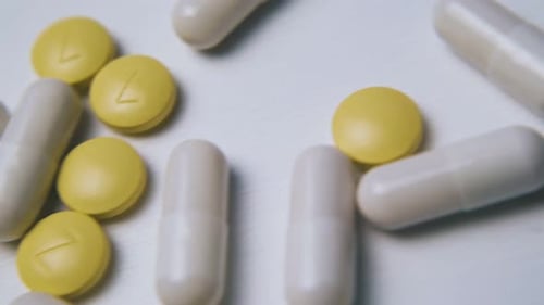 Pills and Capsules on a White Surface