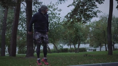 Man Jumping Jacks for Outdoor Fitness in the Park