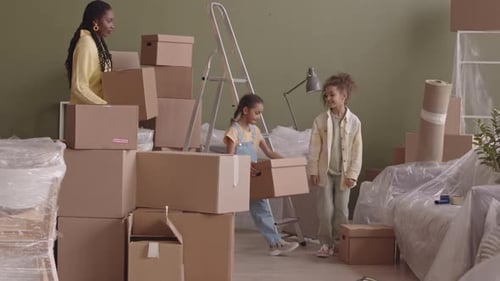 Happy African American Family of Four Moving in New Apartment