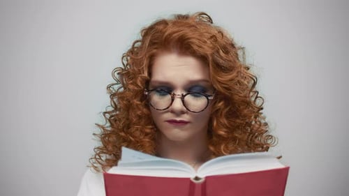 Woman Reading Book Against Grey Background. Female Student Learning with Book