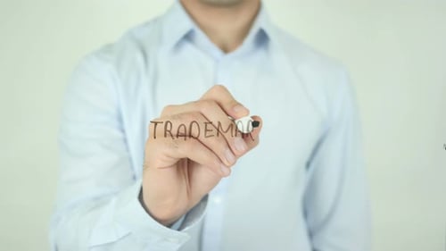 Man Writes Trademark on Glass Surface