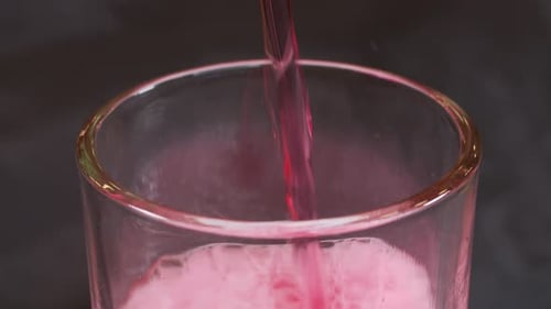 Red Soda Bubbly Drink Poured into Glass