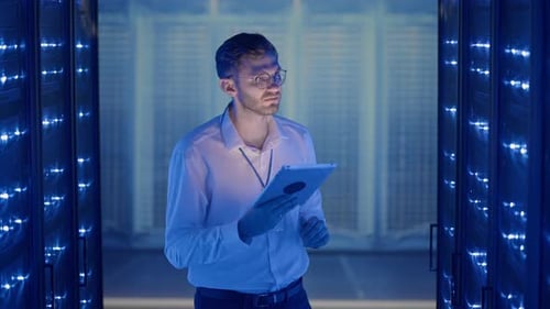 IT Technician in Data Center Digital Server Room Controlling Work of Rack Server Cabinets with a