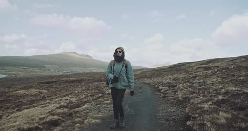 Three people walk together on hillside