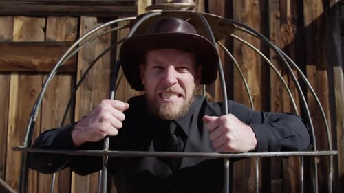 Cowboy dans la cage attaquant la caméra