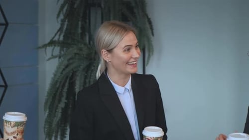 Business Woman Laughs During a Company Meeting