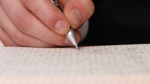Close Up of Hand Writing in a Notebook