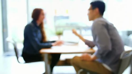 Business Meeting at a Table with Laptop Computer