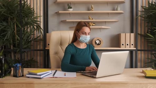 Coronavirus Quarantine. Woman at the Office with Mask for Corona Virus.