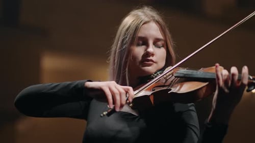 Young Lady is Playing Violin in Music Hall Female Musician is Rehearsing Violinist on Scene