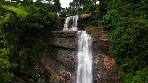 A Beautiful Waterfall Among the Rainforest and Vegetation